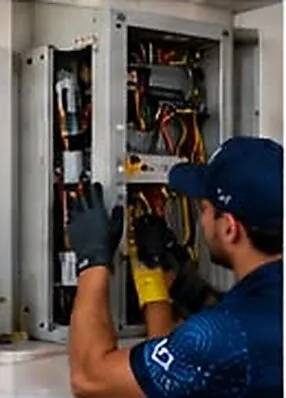 Technician testing an electrical switchboard