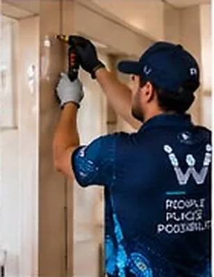 Maintenance technician repairing a wall fitting
